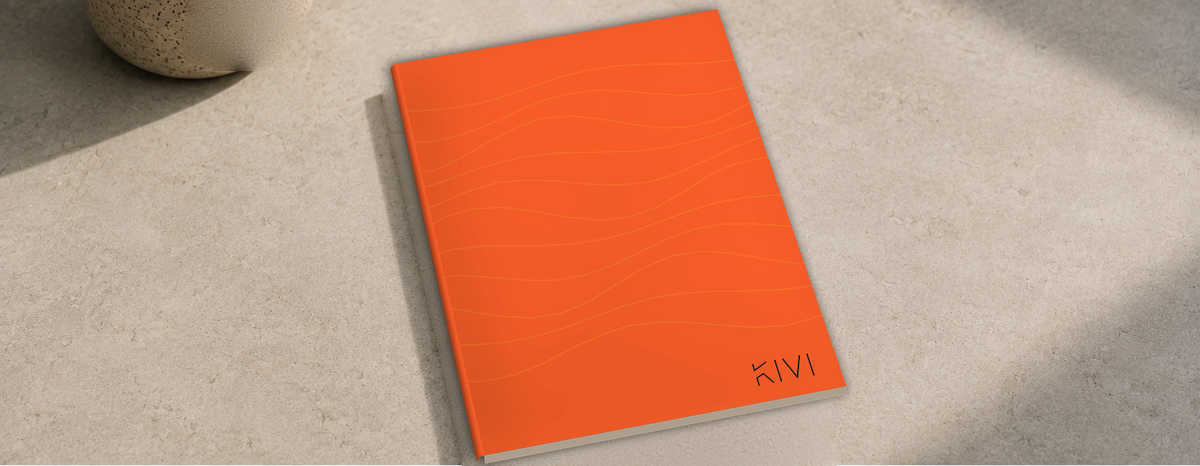 KIVI B6 stone paper notebook in Lava, lying on a stone table